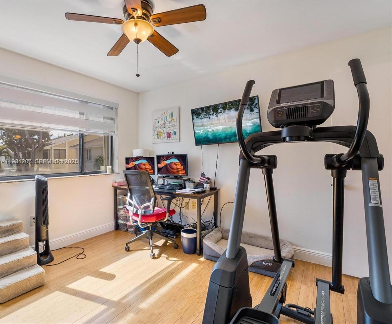 10059 Southwest 218th Street, Unit 10059 Cutler Bay, FL 33190 - Photo 7 of 15 a view of a room with gym equipment