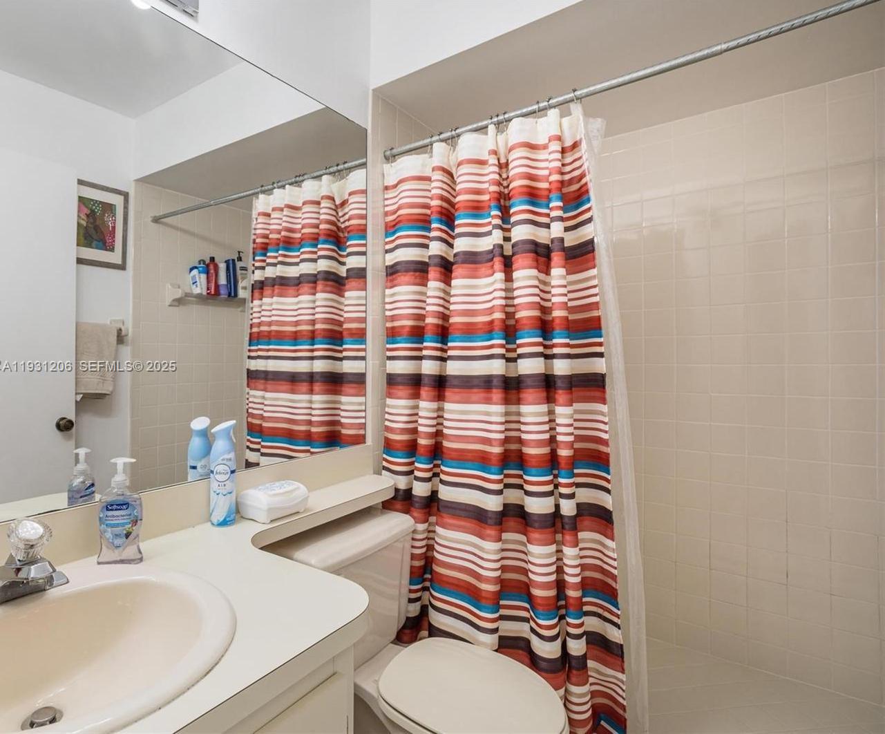 10059 Southwest 218th Street, Unit 10059 Cutler Bay, FL 33190 - Photo 8 of 15 a bathroom with a sink toilet and shower