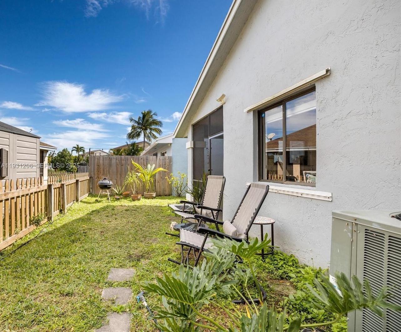 10059 Southwest 218th Street, Unit 10059 Cutler Bay, FL 33190 - Photo 10 of 15 a view of a house with backyard and sitting area