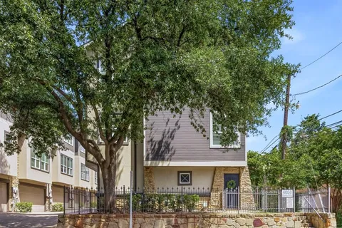 a front view of a building with trees
