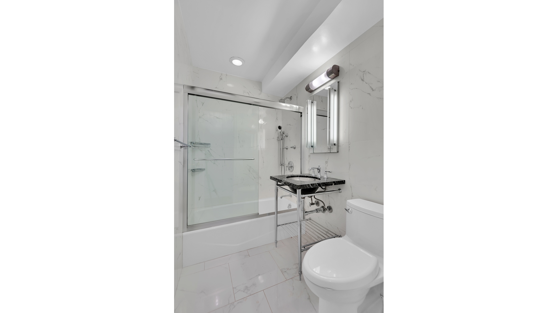 233 East 69th Street, Unit 3L Manhattan, NY 10021 - Photo 6 of 9 a bathroom with a toilet a sink and a shower