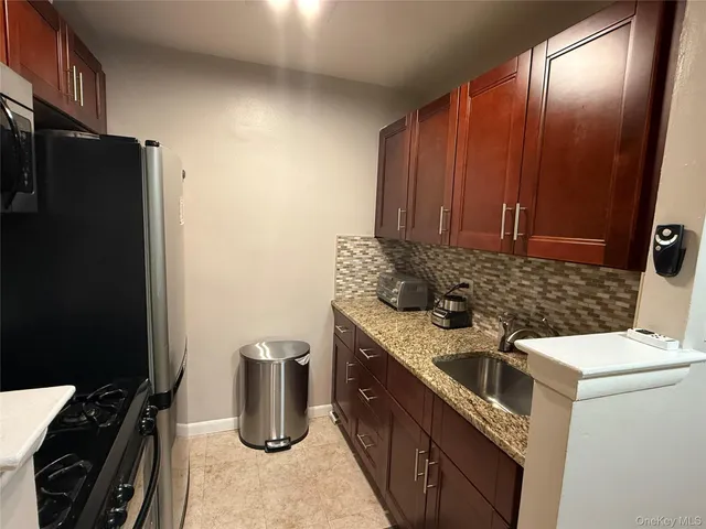 a kitchen with a sink stove and refrigerator