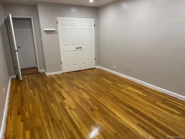 a view of room with wooden floor and entryway