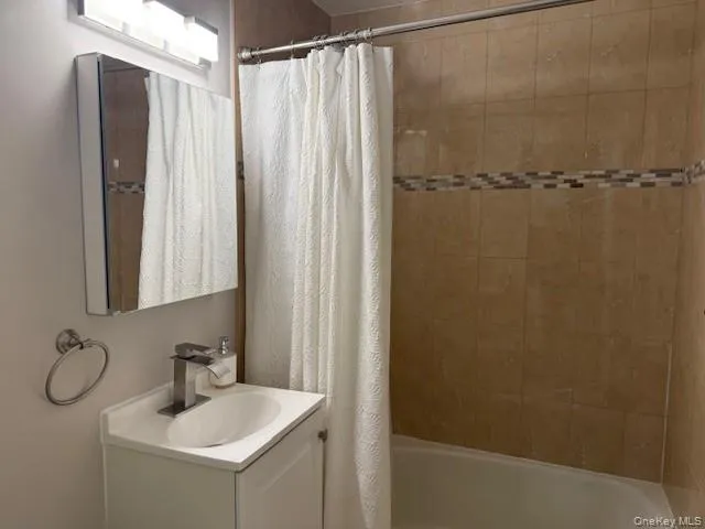 a bathroom with a sink a mirror and a shower