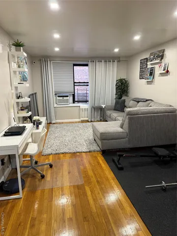 a living room with furniture pool table and kitchen view