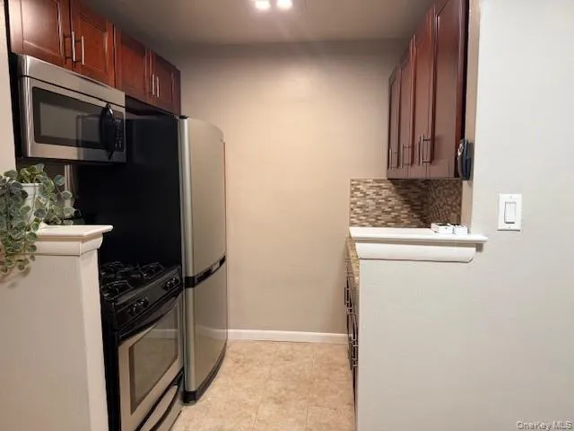 a kitchen with a refrigerator stove and microwave