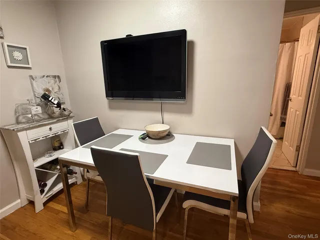 a view of a dining room with a table and chairs