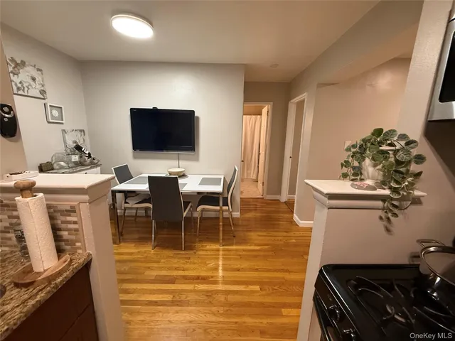 a room with table chairs and flat screen tv