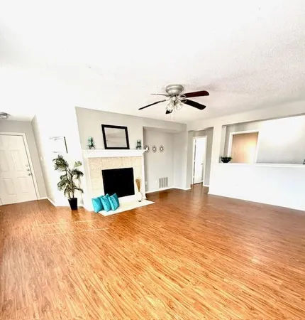 a view of a livingroom with a fireplace and window