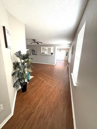 a view of a living room with furniture and a chandelier