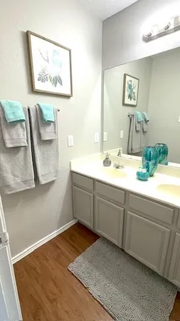 a bathroom with a sink mirror and vanity