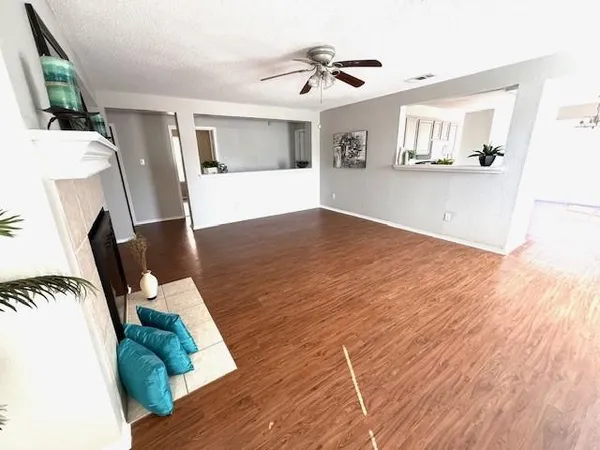 a living room with furniture and a wooden floor
