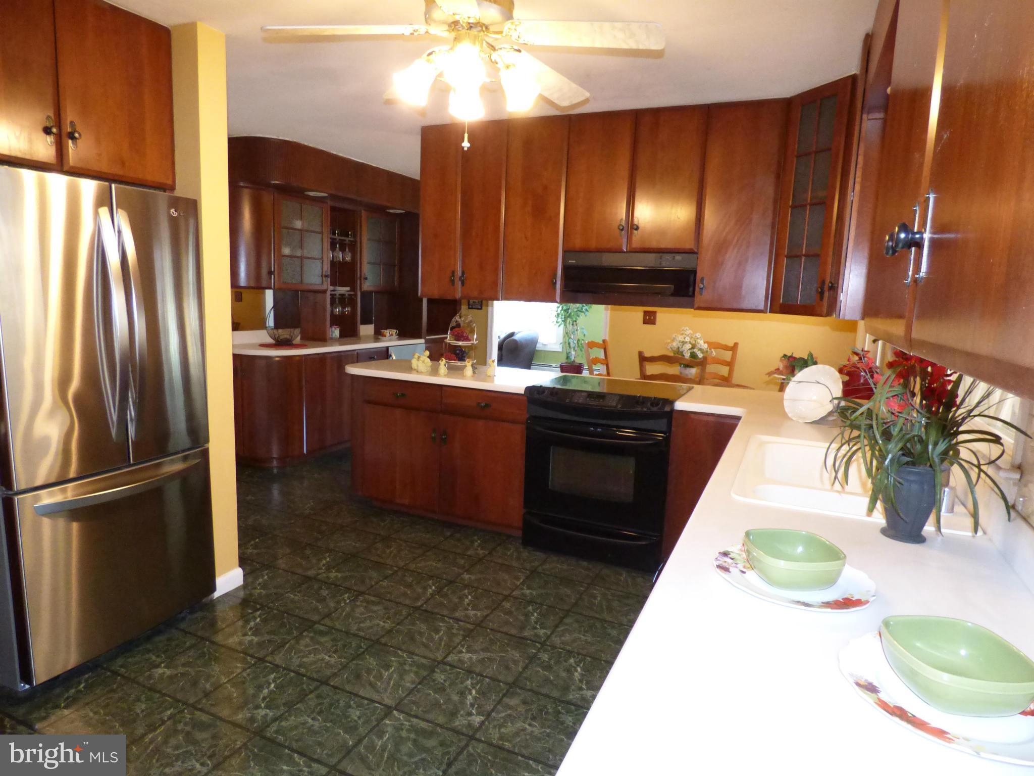 9228 Gue Road Damascus, MD 20872 - Photo 11 of 30 a kitchen with cabinets a sink and stainless steel appliances