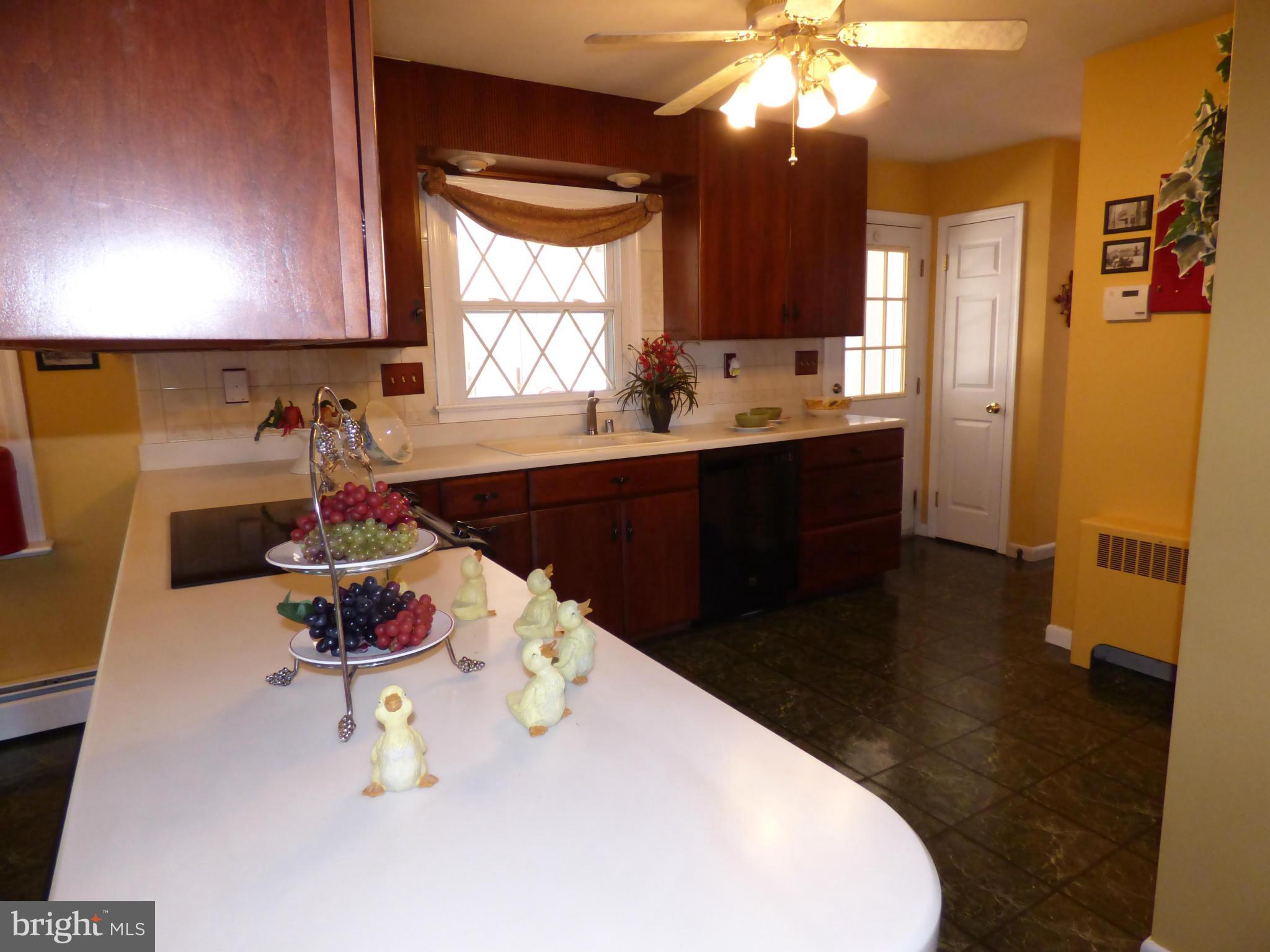 9228 Gue Road Damascus, MD 20872 - Photo 12 of 30 a kitchen with a sink a stove and cabinets