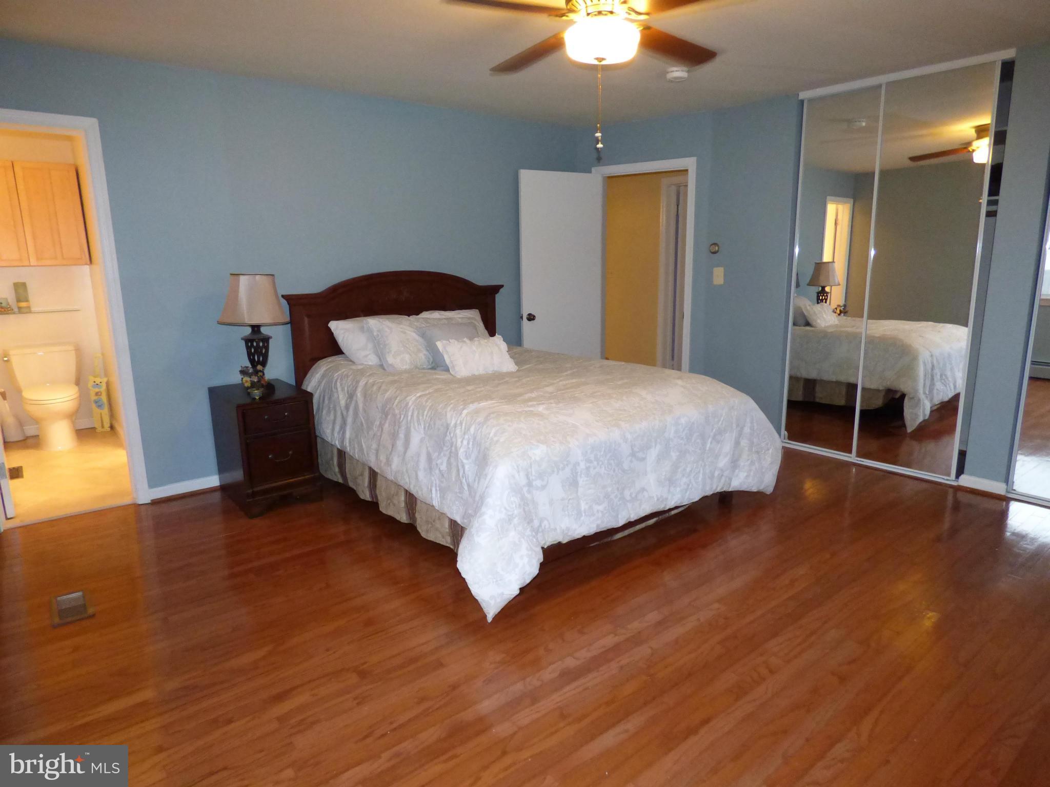 9228 Gue Road Damascus, MD 20872 - Photo 15 of 30 a bedroom with a bed and a chandelier