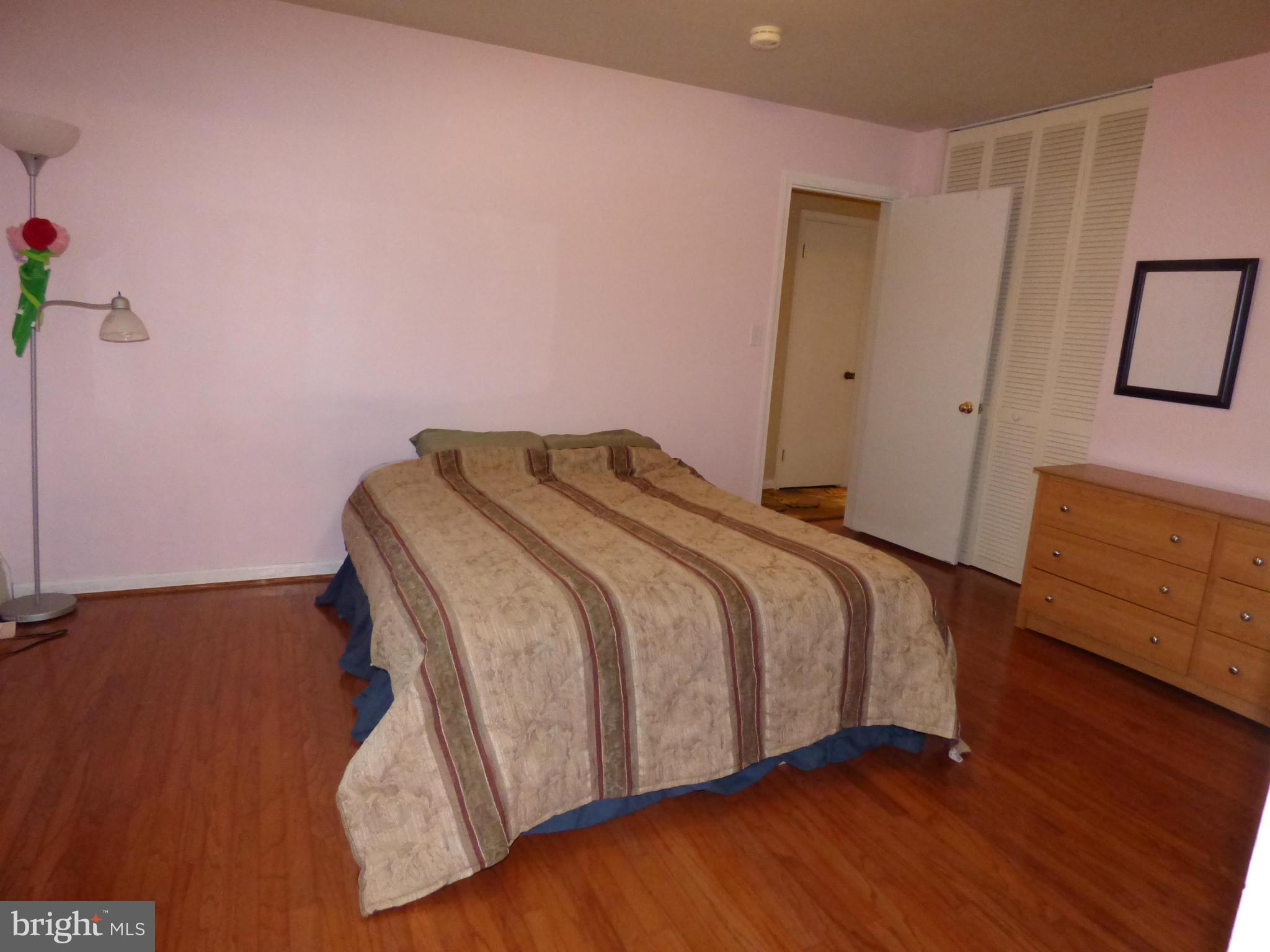 9228 Gue Road Damascus, MD 20872 - Photo 18 of 30 a bedroom with a bed and wooden floor