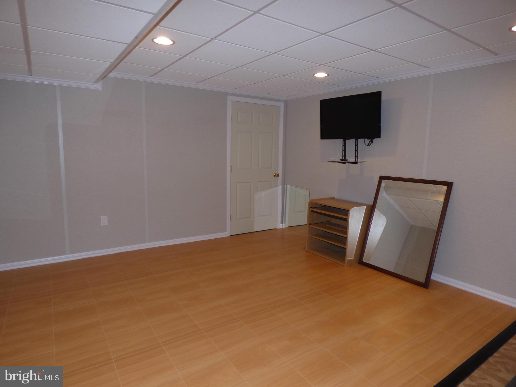 9228 Gue Road Damascus, MD 20872 - Photo 25 of 30 a room with a bed furniture and a flat screen tv