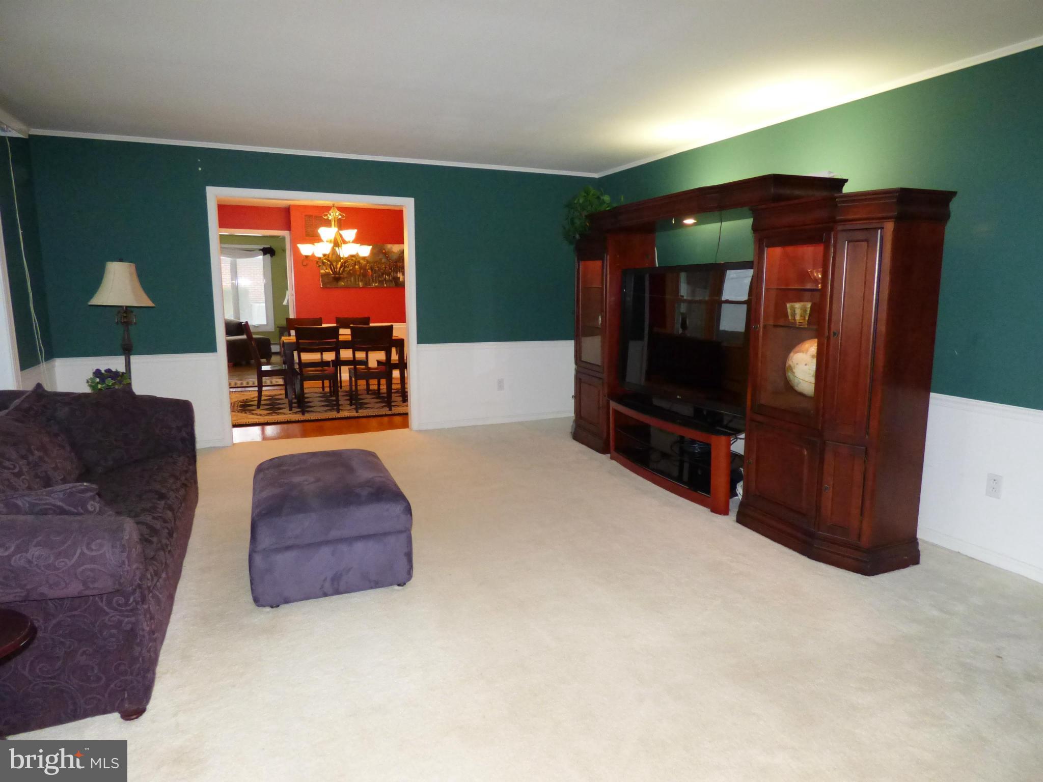 9228 Gue Road Damascus, MD 20872 - Photo 7 of 30 a living room with furniture and a flat screen tv