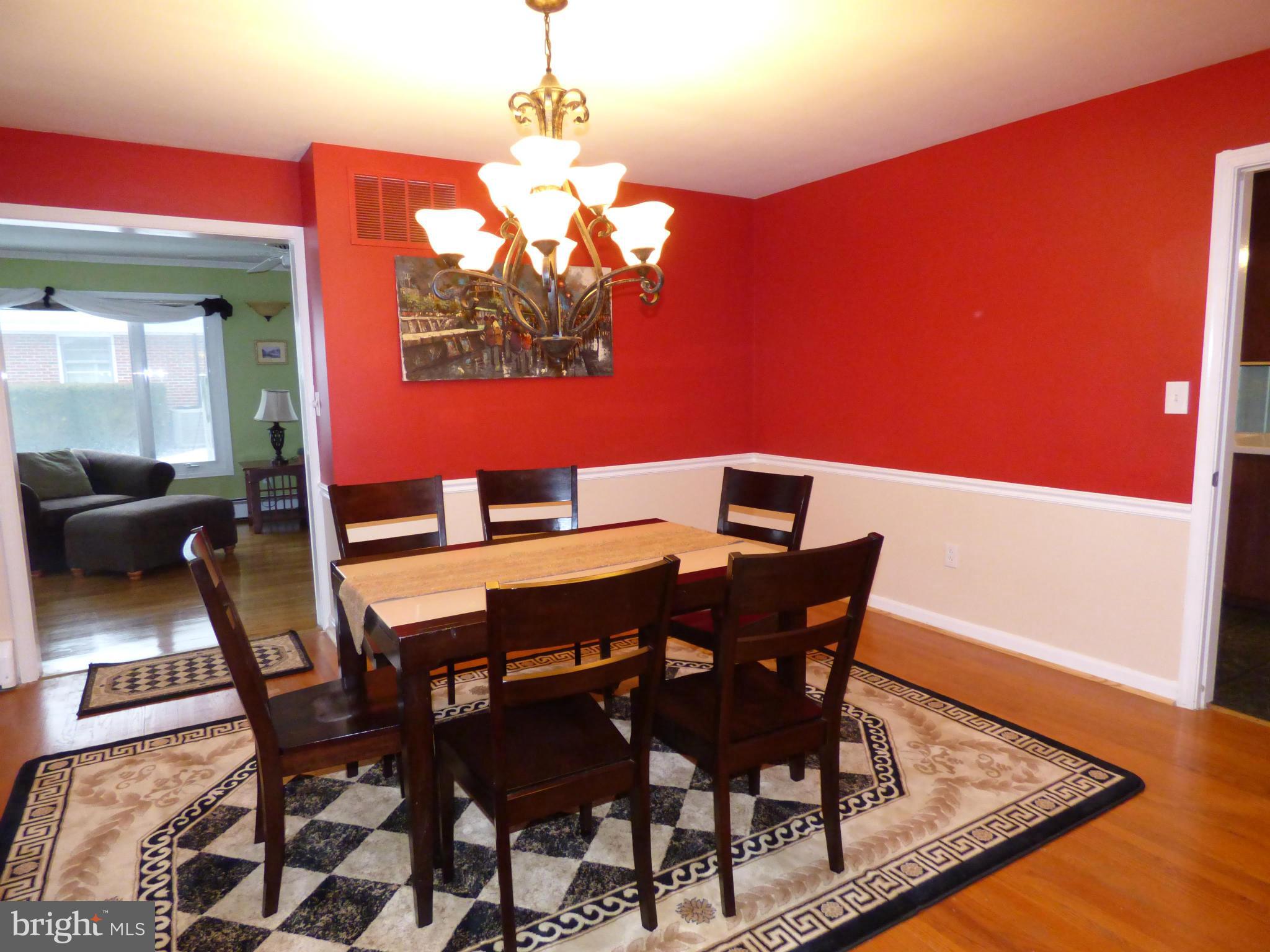 9228 Gue Road Damascus, MD 20872 - Photo 8 of 30 a view of a dining room with furniture a chandelier and wooden floor