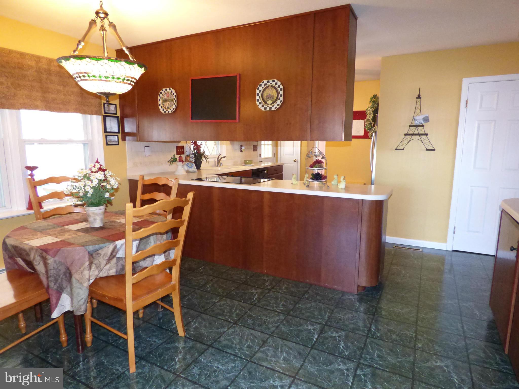9228 Gue Road Damascus, MD 20872 - Photo 10 of 30 a dining area with a table and chairs in it