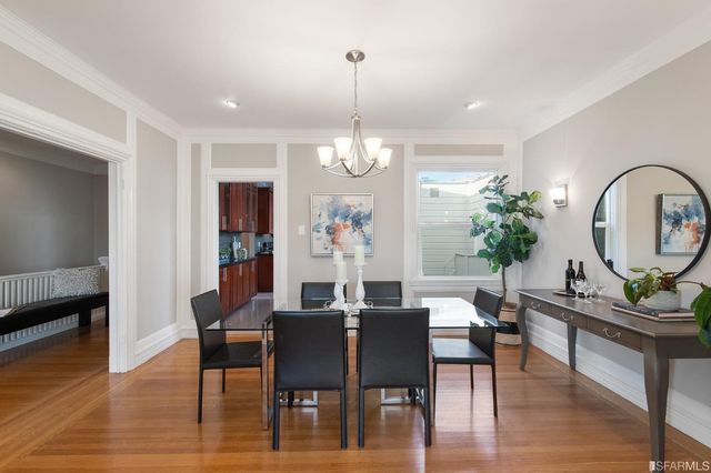 a view of a dining room with furniture wooden floor and chandelier