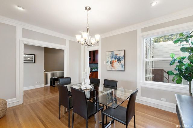 a kitchen with stainless steel appliances a refrigerator and a table