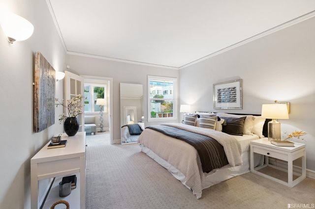 a bedroom with two beds and a table