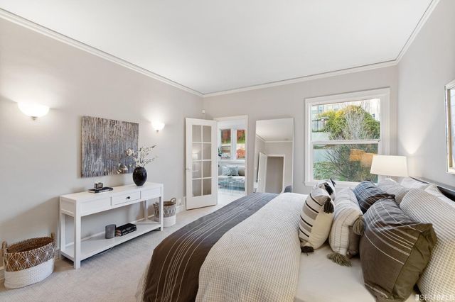 a bedroom with two beds and a desk