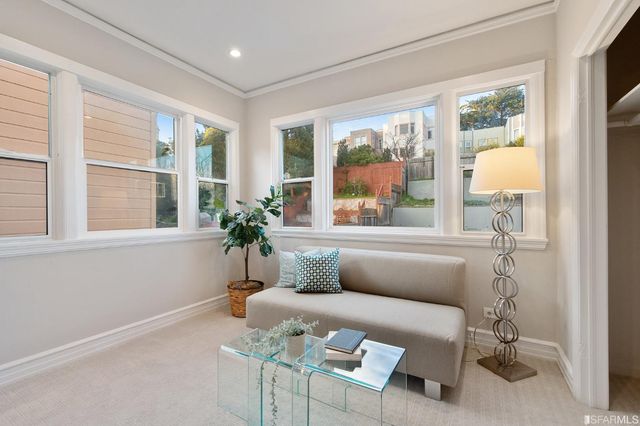 a view of a patio with couches and table and chairs and potted plants