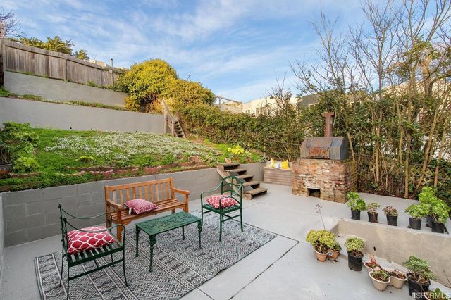 a view of a house with backyard and trees