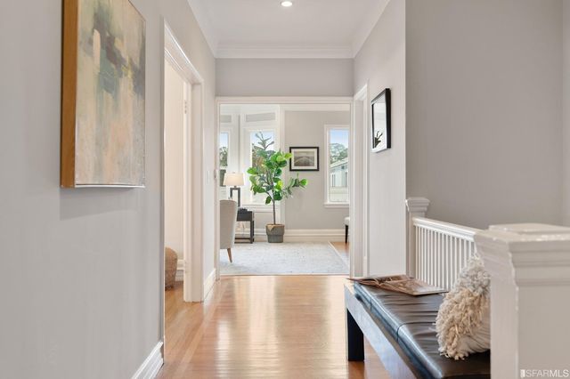 a view of a hallway to a livingroom with furniture