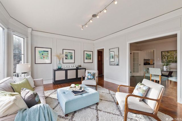 a view of a livingroom with furniture window and wooden floor