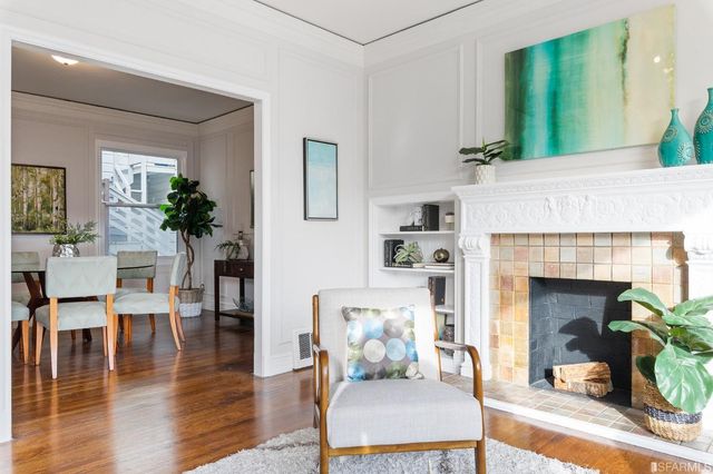 a kitchen with stainless steel appliances a sink a stove a refrigerator dining table and chairs