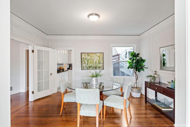 a kitchen with granite countertop stainless steel appliances a sink stove and refrigerator
