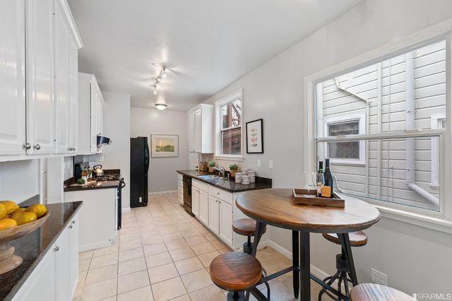a kitchen with granite countertop a sink and cabinets