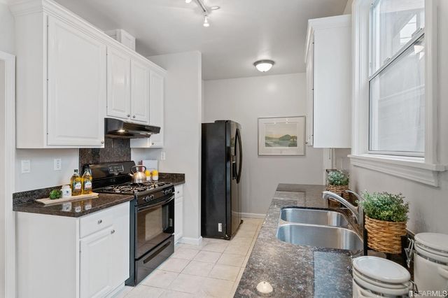 a bathroom with a granite countertop sink a mirror a shower and a bathtub