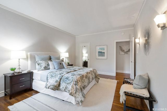 a bedroom with a bed and wall painting