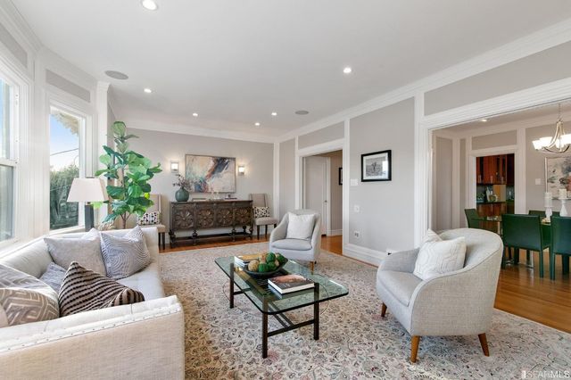 a vase of flowers sitting on a table with window