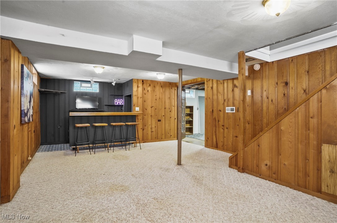 1071 Chalker Street Akron, OH 44310 - Photo 20 of 23 Basement featuring carpet, indoor bar, and wood walls