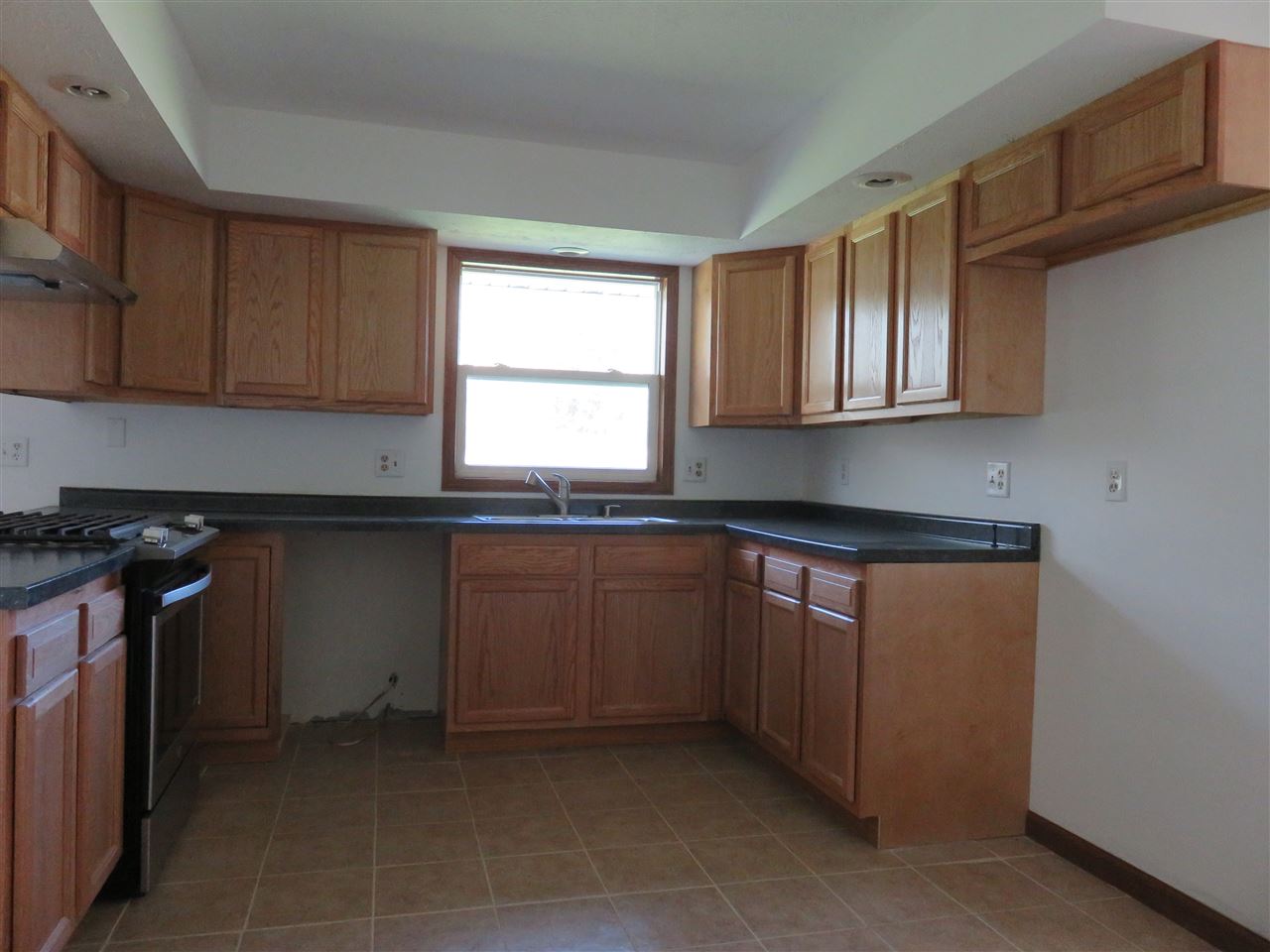 12140 Tresemer Road Roscoe, IL 61073 - Photo 6 of 17 a kitchen with granite countertop a sink and a stove