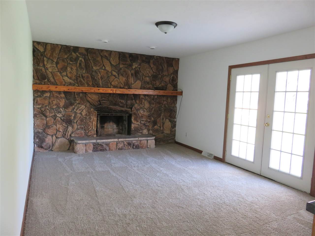 12140 Tresemer Road Roscoe, IL 61073 - Photo 9 of 17 a view of empty room with a fireplace
