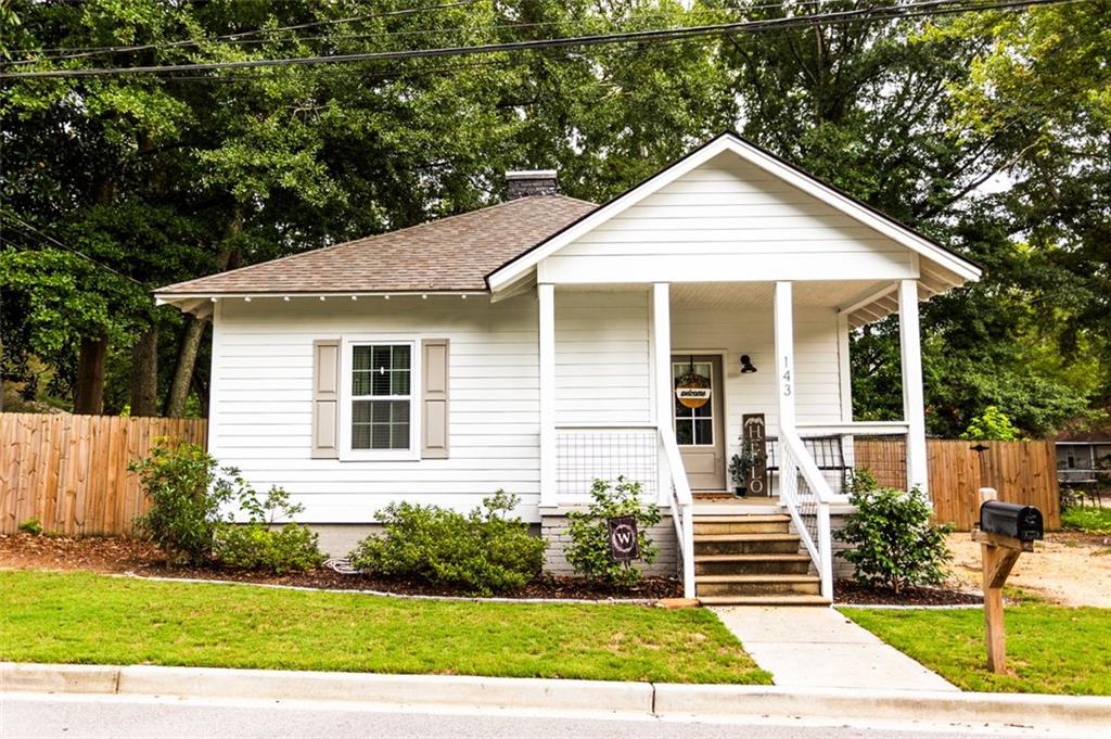 143 West 5th Street Monroe, GA 30655 - Photo 1 of 1 a front view of a house with a yard