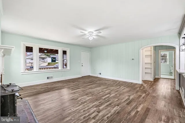 wooden floor in an empty room with a window