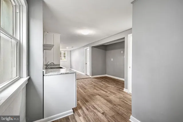 an empty room with windows and closet