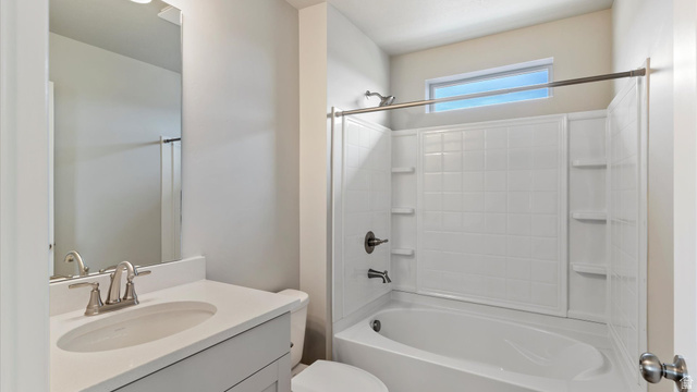 82 Provo River Road, Unit 251 Saratoga Springs, UT 84045 - Photo 25 of 32 Bathroom featuring a vanity with an integrated sink, brushed nickel faucet, and a large wall-mounted mirror