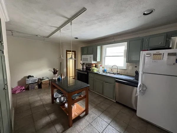 a kitchen with refrigerator and cabinets