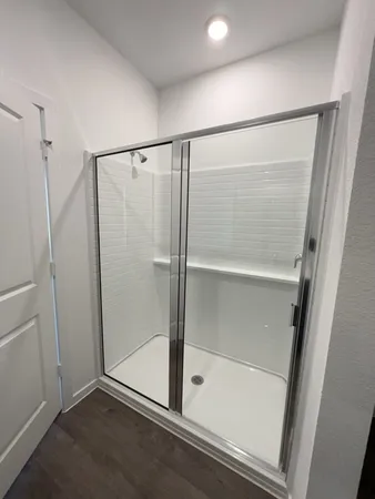 a bathroom with a glass shower door