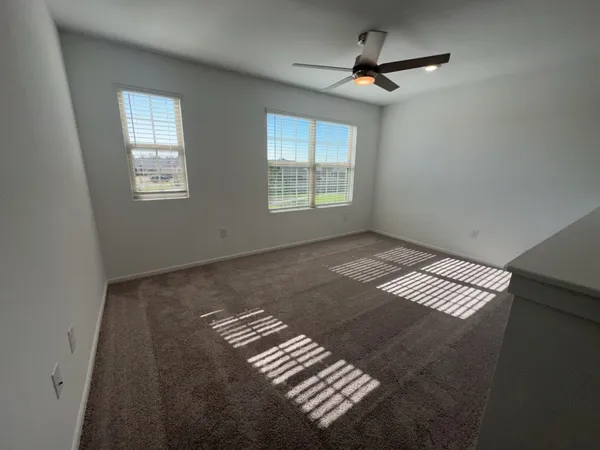 a view of an empty room with windows