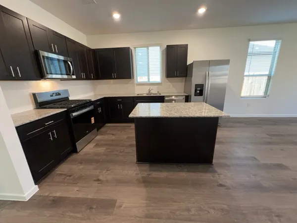 a kitchen with a sink stove and microwave