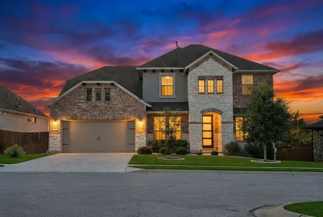 a front view of a house with a yard